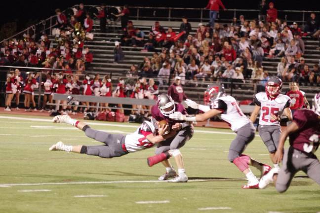 High Point defenders reach Newton quarterback Jack Young in the first half. Young passed for 339 yards resulting in 4 touchdowns.