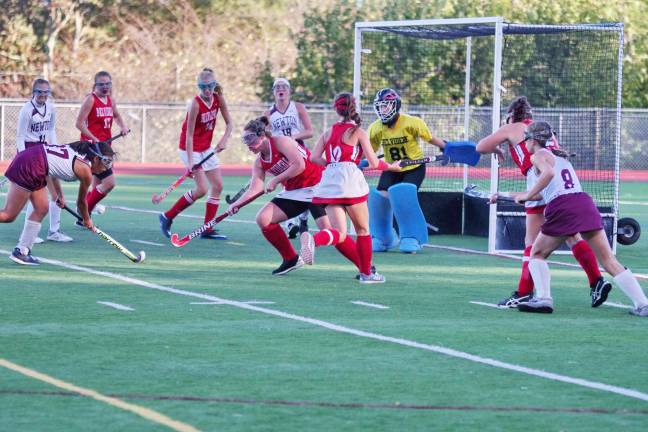 Belvidere County Seaters (red) and Newton Braves battle for control of the ball near the goal post in the second period.