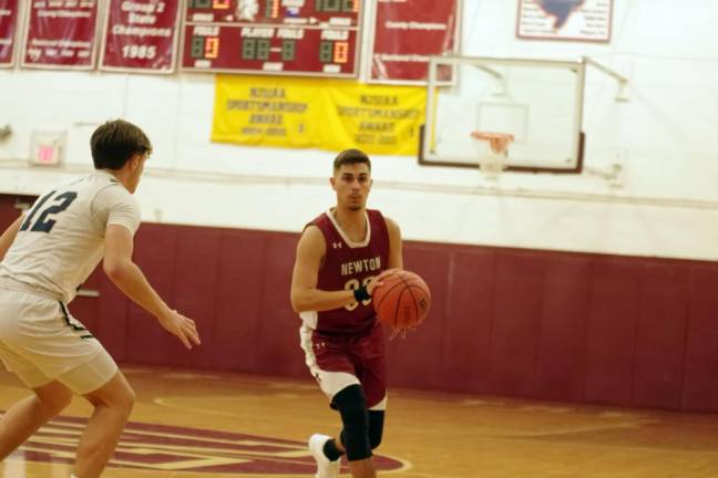 Newton's Jack Hunterton with the ball in the first period.