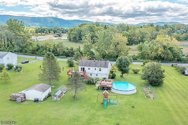 Fruit trees, pool, and gleaming hardwood floors are among this home’s amenities