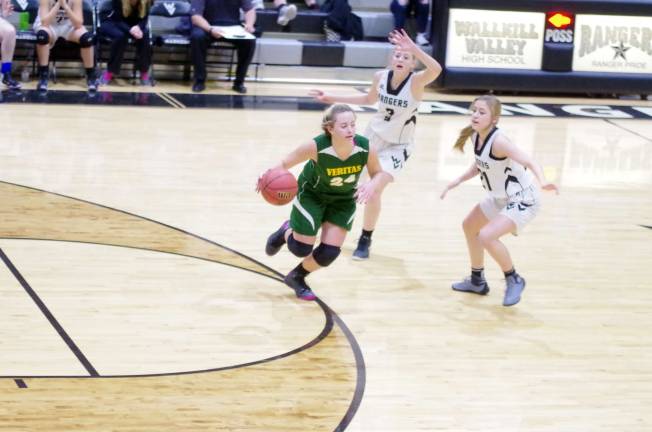 Veritas girls beat Wallkill in hoops Veritas Christian's Karlea Zazopoulos dribbles the ball while covered by Wallkill Valley defenders. Zazopoulas scored a game- high 19 points.