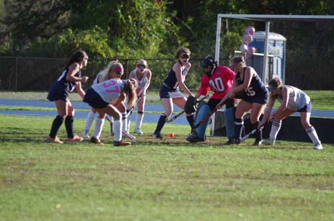 Players battle for the ball in front of the Lenape Valley goal post.