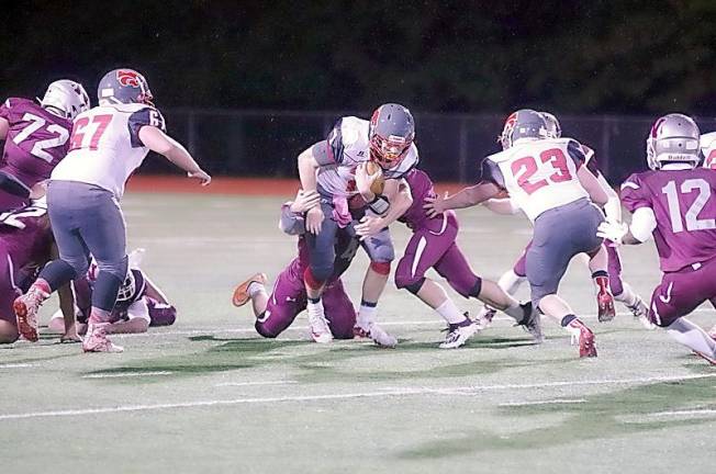 High Point quarterback Alex Buchwald is tackled by Newton defenders in the first half (Photo by George Leroy Hunter)