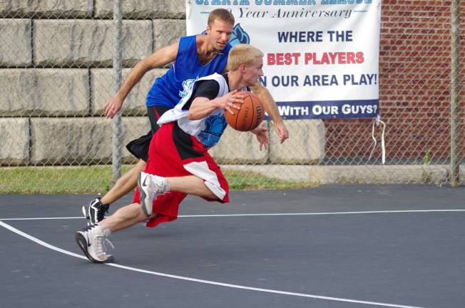 Smalley beats Basket in summer basketball Team Basket's Noah Basket dribbles the ball as Team Smalley's Brandon Mefford keeps pace.