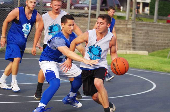 Smalley beats Basket in summer basketball Team Smalley's Jamie McKenna reaches in while covering Team Basket ball handler Jimmy Mantione.