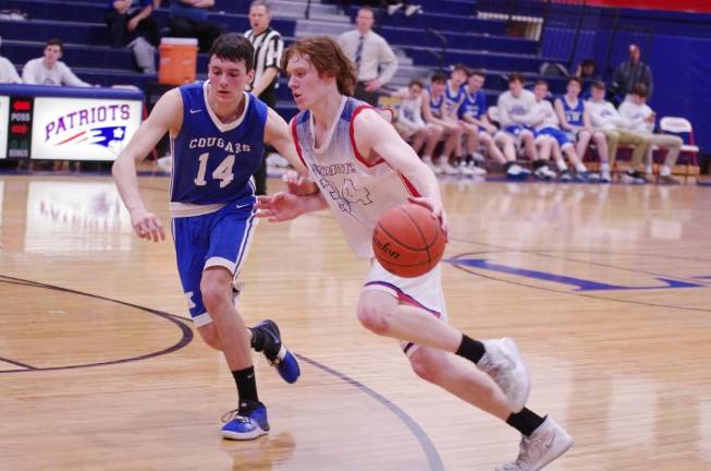 Kittatinny defeats Lenape Valley in boys' varsity basketball Lenape Valley's Troy Brennan dribbles the ball while Kittatinny's Dylan Modafferi tries to keep pace in the second half.