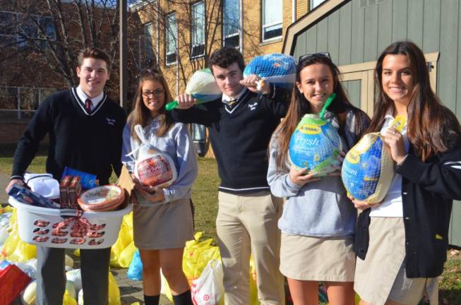Community delivers holiday meals Students helped distribute Thanksgiving meal items.