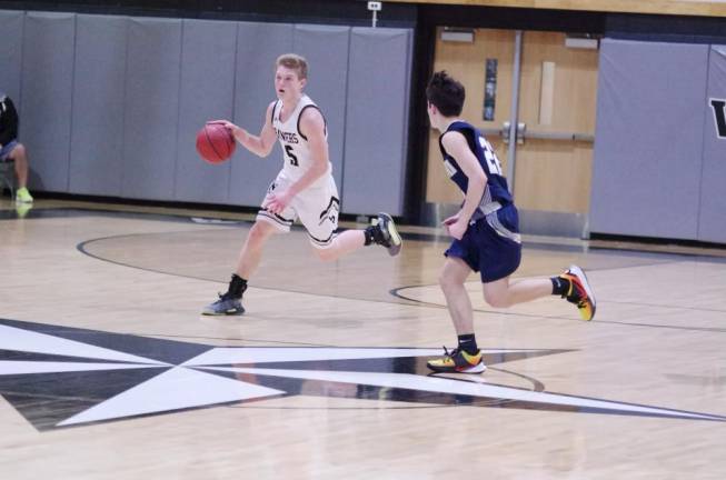 Wallkill Valley's Shawn Falk dribbles the ball while covered by Pope John's Jack Sakowski during the second half. Falk scored 13 points.