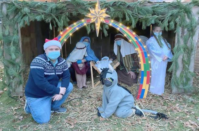 ‘Ye shall find the babe wrapped in swaddling clothes, lying in a manger’ Nativity players gather at the manger (Photo courtesy of Father Julio)