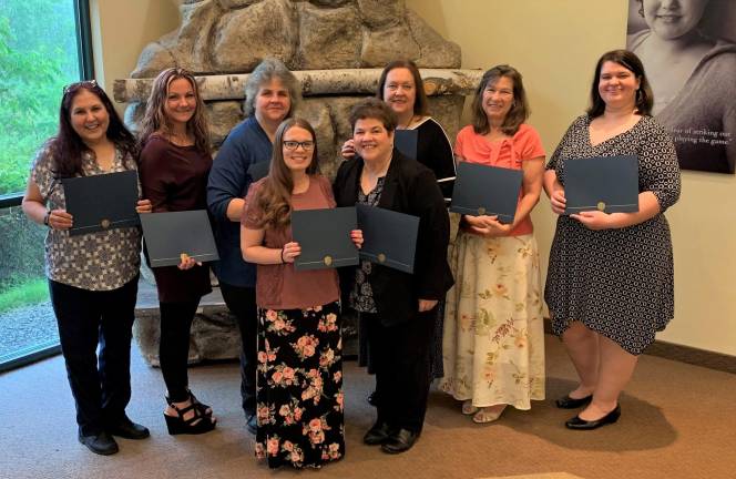 Participants from the most recent HOW graduating class at Project Self-Sufficiency display their certificates of achievement