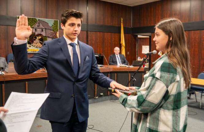 BY3 Richard Proctor takes the oath for a seat on the Township Council. Holding the Bible is Brooke Proctor.