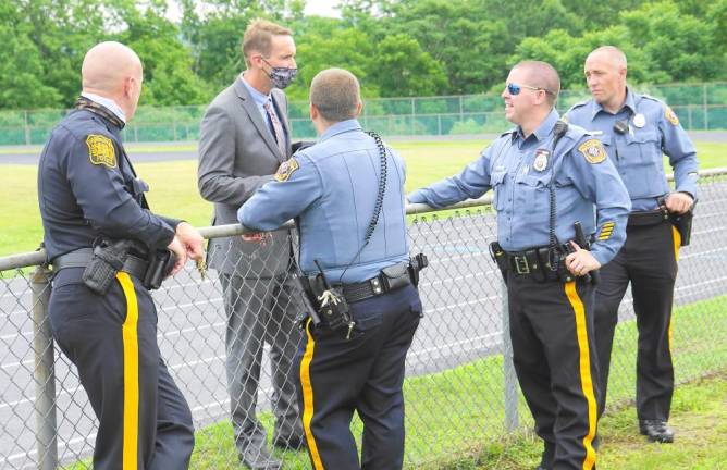 ‘All eyes are on the Class of 2020’ Superintendent David Carr speaks with local police officers. (Photo by Vera Olinsky)