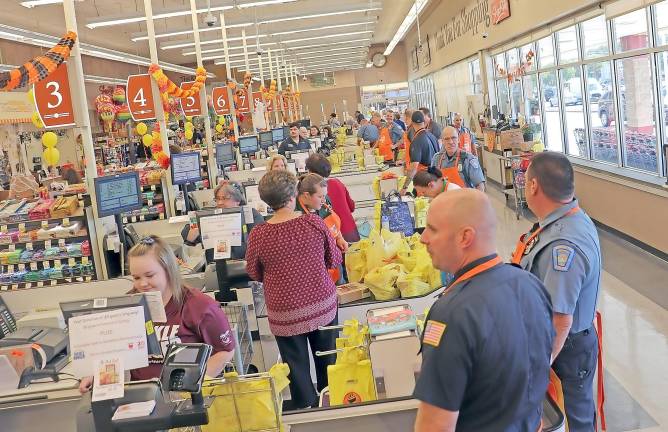 Local police bagged groceries recently at ShopRite to raise awareness of the need to end hunger.