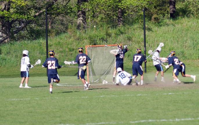 Sparta boys top DVRHS in lacrosse in semis, win championship The ball soars over the goal post as players clash.