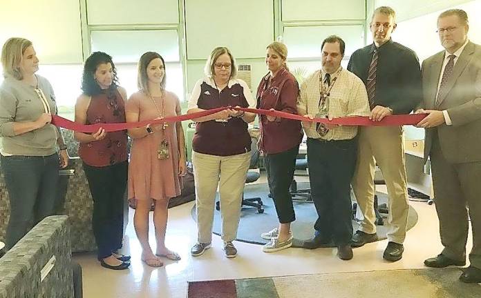 A ribbon cutting was held on Friday for Newton High School's new Green Room. Project coordinator, Karen Mazur cuts the ribbon.