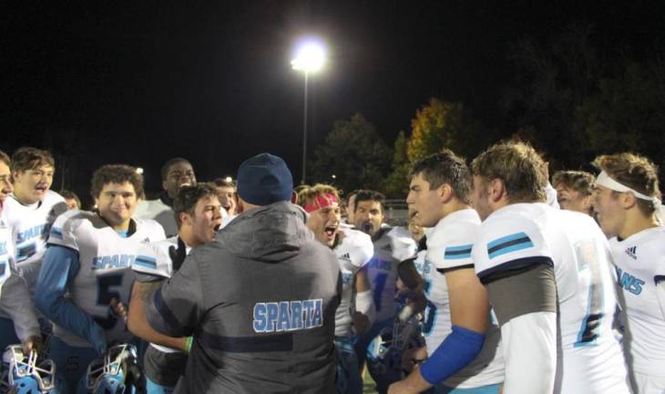 Spartans call out their victory cheer after Coach Marchiano's post-game huddle.