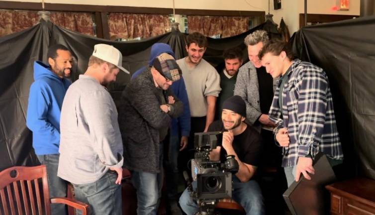 The cast watches the dailies with Kevan Ali, who is standing behind the camera in a blue hoody. (Photos provided)
