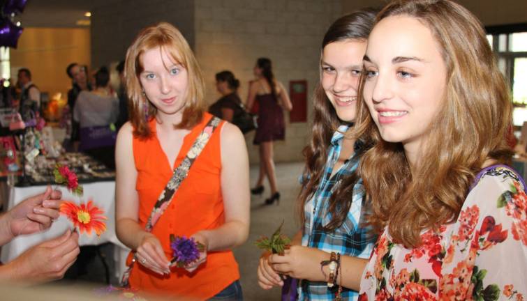 Girls, girls and more girls Bridget Hagdon, Katie Callahan and Melissa Terhune all of Sparta made flower pens at the girl scout vendor table.