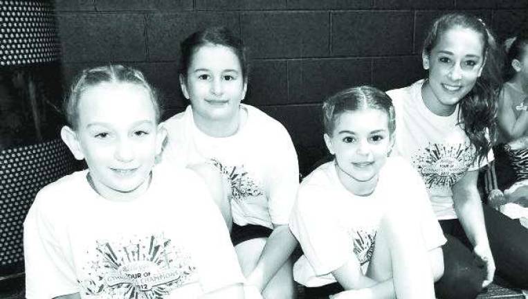 Local gymnasts perform with champions Local gymnasts perform with champions