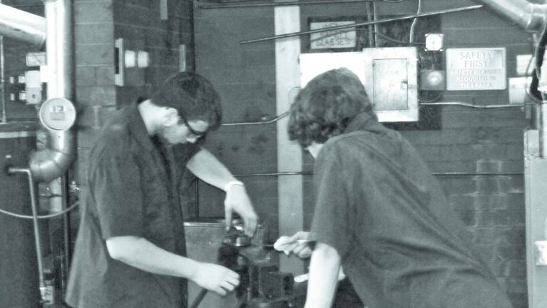 Focus on Sussex Tech School programs Photo provided Seniors Mike Clint, left, and Mark Eberle refurbish a black pipe threading die.  