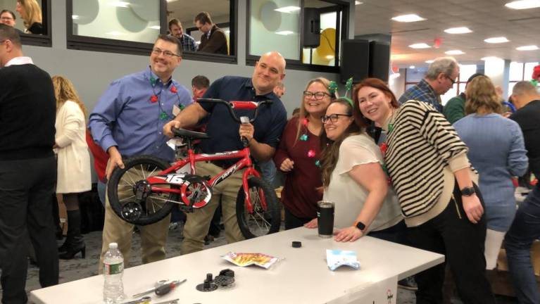 The first team to put their bike together poses for a photo.