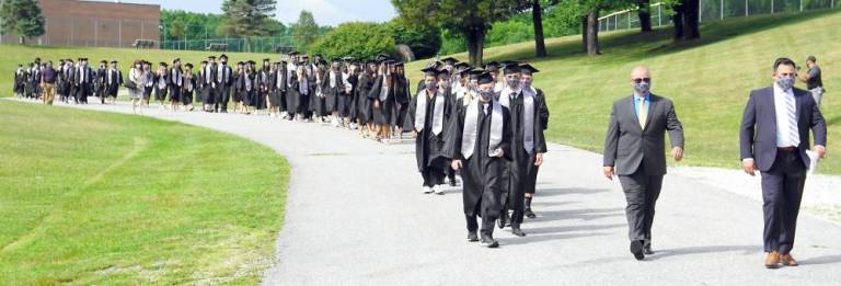 ‘All eyes are on the Class of 2020’ Students walk to the football field. (Photo by Vera Olinsky)