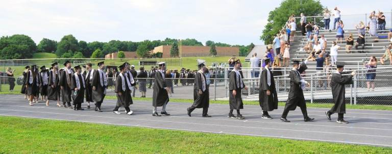‘All eyes are on the Class of 2020’ Students progress to Pomp and Circumstance, with cheers. (Photo by Vera Olinsky)