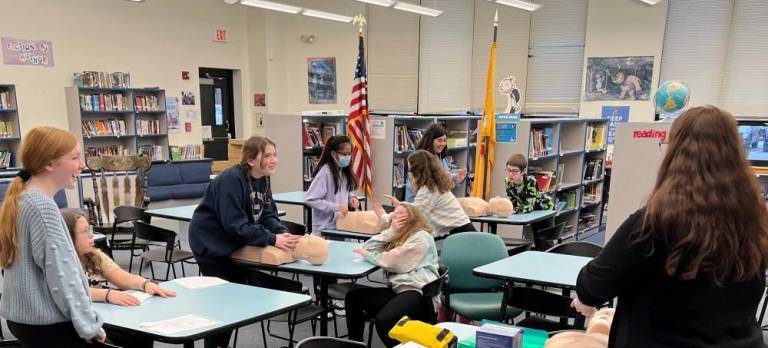 Jessica Frank, a registered nurse, shows students how to administer CPR at Valley Road School in Stanhope. (Photo by Nicholas Lalama)