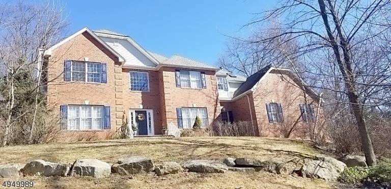Stately brick-front colonial at Woodcrest Lake offers privacy Stately brick-front colonial at Woodcrest Lake offers privacy