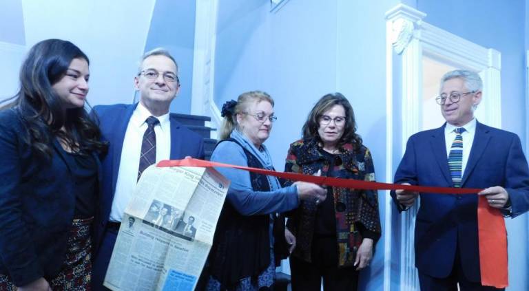 (L-R) Raquel Hiben, Chris Colabella, Newton Councilwoman Sandy Diglio, Freeholder Sylvia Petillo, and Mark Gruber cut the ribbon to rededicate Gruber and Colabella's office building on Tuesday, Nov 12, 2019. Colabella holds a newspaper from 1995, depicting the partners and late partner Carmen Liuzza; Hiben as a child; and Councilwoman Diglio's late husband Phillip, cutting the ribbon after the building was first acquired by the law firm.
