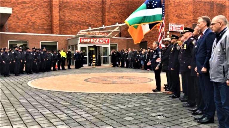 Assembled NYPD officers wait outside Lincoln Medical Center in the Bronx for Lt. Jose Gautreaux's release following an assassination attempt Sunday.