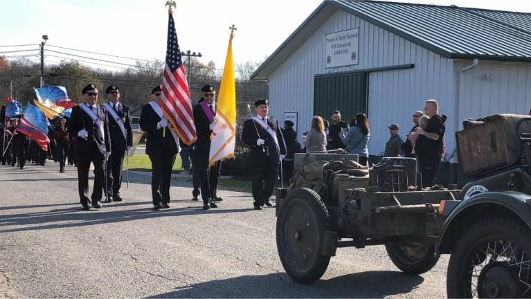 Veterans honored with parade, ceremony Flag bearers are followed by the Newton High School marching band.