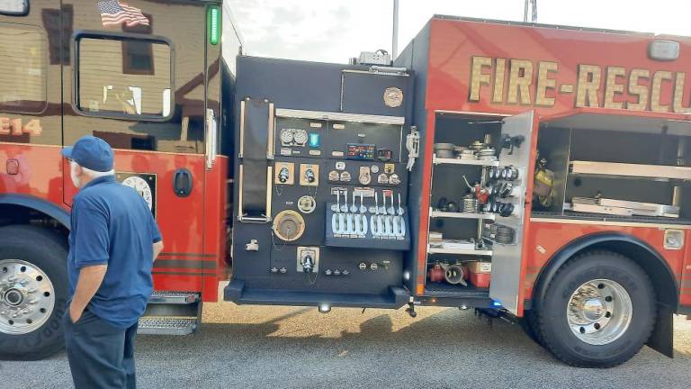 Hardyston celebrates arrival of new fire engine, which gets put to use right away Firefighter Frank Lacatena admires the new Rosenbauer (Photo by Laura Marchese)