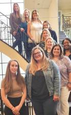 Tina Magarino, executive director of Birth Haven, is at the top of the staircase. With her are members of the April Showers annual fundraiser committee. (Photos by Ava Lamorte)