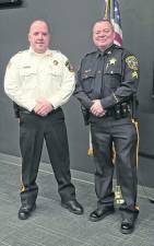 Sussex County Sheriff Michael Strada stands retiring Corporal Brian Snyder.
