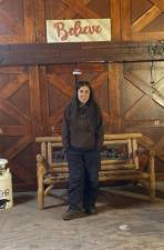 Diane Romano in the barn under her 'Believe' sign. She believes the sanctuary can persevere.