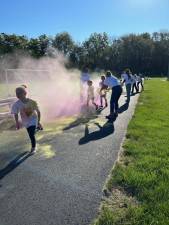 HH1 Runners go through a color station during the second annual Hawk Hustle Color Run on Sunday, Sept. 17 at the Hampton Township Recreation Fields in Newton. (Photos by Daniele Sciuto)