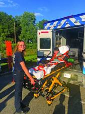 TN1 Morgan Saulys, a Newton emergency medical technician, shows Julian Dixon, 3, of Newton what it’s like to be strapped on a gurney and put in the back of an ambulance at the National Night Out event Tuesday, Aug. 1 in Newton. (Photos by Greg Smith)
