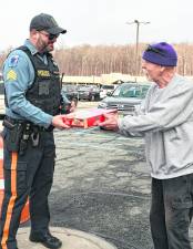 Butch Fiorentino of Byram presents a box of lasagna to Sgt. Chris Spaldo.