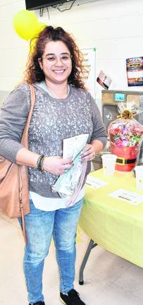 Kim Dunn of Sparta is shown in front of table of items.