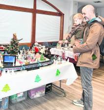 <b>Coyote and his father, Mike, Moeller of Lake Hopatcong look at a train display.</b>