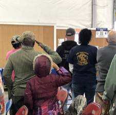 Veterans and their families salute as rifles are fired outside the annual Salute to Military Veterans on Sunday, Nov. 5 at the Sussex County Fairgrounds. (Photo by Kathy Shwiff)