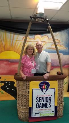 Carol and Rich Schubert pose for a photo at the balloon basket, after checking in at the Senior Olympics in New Mexico.