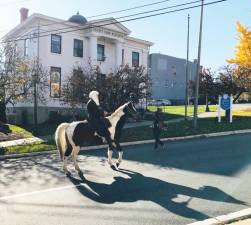 Reverend Canon Robert Griner travels past the Town Green on horseback on his way to the 250th anniversary of Christ Episcopal Church on Sunday, Nov. 3, 2019.