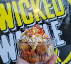 Waffle balls topped with bananas, caramel and fruity pebbles from The Wicked Waffle Stick.
