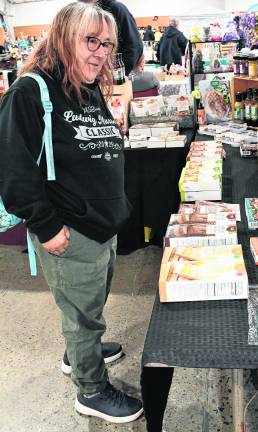 <b>Kim Kampka of Stillwater looks at items for sale.</b>