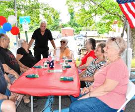 Mayor Thomas Walsh, standing, talks to residents of Mohawk Meadows, a rehabilitation and nursing center in Andover Township, during ‘Grill and Gab with the Mayor’ on July 1. (Photo by Maria Kovic)