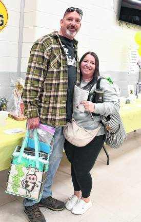 Michael Stivens and Kelly Beck, both of Hamburg are shown in front of the table.