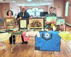 Some items that are to be sold at the 77th Lords Auction. Pictured, from left, Kathleen Heeney, Pastor Fred Laux and Charlene Cook.