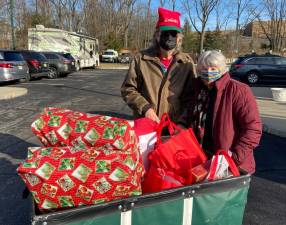 Alice and Kevin Prendergast assemble gift bags for local senior citizens as part of Project Self-Sufficiency’s Earth Angels initiative.